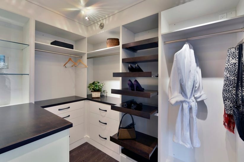 A custom closet with pull-out organizers.